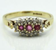 A 9ct gold ring set with diamond & pink sapphires,