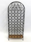A 20thC. fifty seven bottle metal wine rack, 1295m