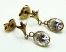 A pair of yellow metal earrings set with paste sto