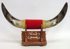 A mounted set of water bull horns with carved & fi