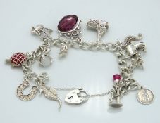 A Birmingham silver & white metal charm bracelet i