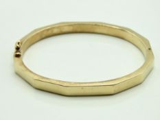 A 9ct gold faceted bangle, 12.8g, internal measure