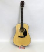 A Fender DG-5NAT acoustic guitar with various plec