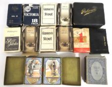 A quantity of vintage playing cards including adve