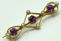 An antique 15ct gold bar brooch set with amethyst