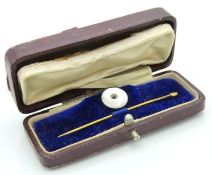 An antique yellow metal stick pin, tests electroni