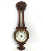 An oak cased enamelled dial aneroid barometer with