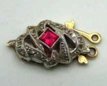 An 18ct gold art deco clasp set with diamond & rub