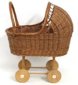 A wicker child's push along dolls pram, 600mm high