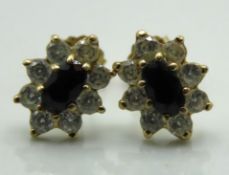 A 9ct gold pair of sapphire & paste set post fit e