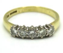 An 18ct gold ring set with five diamonds of approx