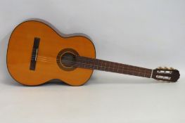 A Takamine G-Series G124 acoustic guitar with Ritter soft case, tuner & strap