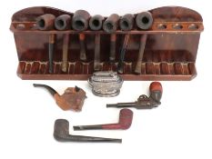 A pipe rack containing eleven pipes, including two