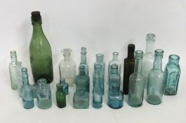 A selection of vintage glass bottles including C M