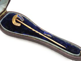 A Victorian yellow metal horse shoe tie pie set with diamond & sapphire, tests electronically as