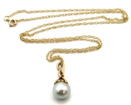 A 9ct gold chain with antique yellow metal set pearl pendant, tests electronically as 14ct gold,