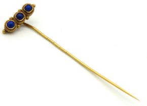 A yellow metal tie pin set with three small sodalite/lapis stones, tests electronically as 15ct