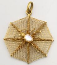An Edwardian yellow metal spider web pendant set with mother of pearl, tests electronically as