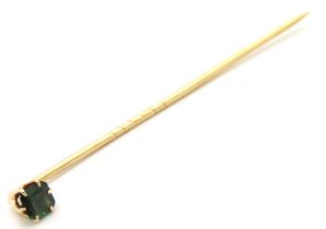 A Victorian yellow metal tie pin set with green stone, possibly garnet, tests electronically as 15ct