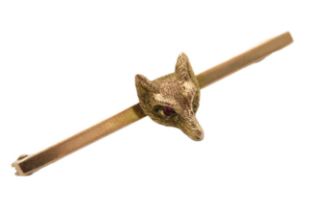 An antique 9ct gold bar brooch with fox head set with ruby eyes, 38mm wide, 2.4g