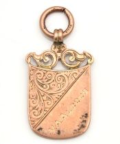 A 9ct rose gold watch chain fob with carved decor inscribed "V. A. Aldous" to fore & "Rowley Conwy