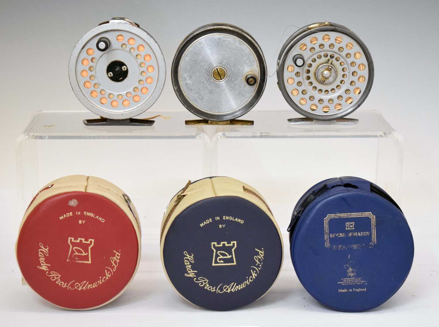 Two Hardy Bros Ltd reels together with a Ogden Smiths reel