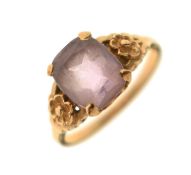 Yellow metal dress ring set an amethyst coloured stone
