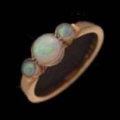 Yellow metal opal three stone ring