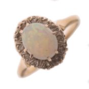 Opal and diamond yellow metal ring