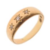 Gypsy set three stone diamond yellow metal ring
