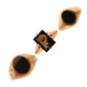 Two 9ct and black onyx rings together with a similar yellow metal example