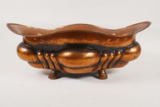 An early C20th hammered copper Art Nouveau jardiniere raised on paw feet, 43 x 30cm