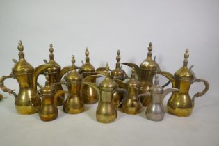 A collection of eleven Islamic brass coffee pots, largest 39cm high