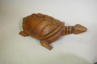 A carved hardwood turtle, 63cm long