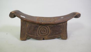 African tribal carved wood stool with scroll ends, 63 x 23 x 26cm