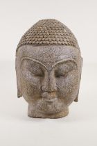 A South East Asian carved stone Buddha head, 30cm high, 18kg