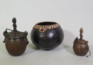 Two Indonesian Sumatran Toba Batak carved wood containers, with covers, and a nut bowl inset with
