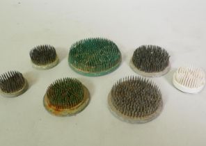 Six vintage lead flower frogs and one composite, largest 11cm diameter