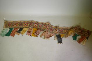 A vintage Indian Banjara textile tapestry hanging, 276cm long