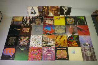 A collection of 1960s and 70s rock vinyl LPs, including Led Zeppelin, Cream, Yes, Pink Floyd, King