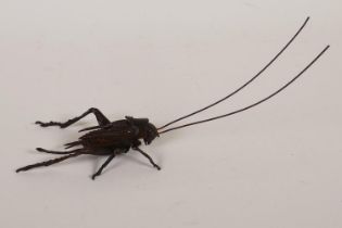A Japanese Jizai style bronzed copper okimono grasshopper with articulated limbs, 17cm long