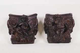 Architectural salvage, a pair of C18th/C19th bacchanalian carved wood capitals, 18 x 18cm