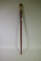 A hardwood staff with archaic style decoration and a shaped soapstone top, 153cm high