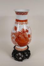 An C18th/C19th Chinese porcelain vase with iron red decoration of a kylin and dragon surrounded by