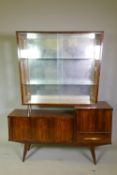 A mid century figured walnut side unit with glazed upper part over three cupboards and single