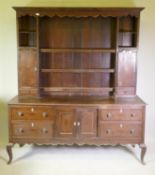 C19th crossbanded oak dresser, the upper section with open shelves over two cupboards flanking a