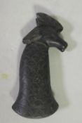 An Eastern hardstone carved dagger handle with bird finial, 13cm long