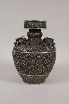 A Chinese white metal vase with raised dragon, bat and floral decoration, impressed seal mark to