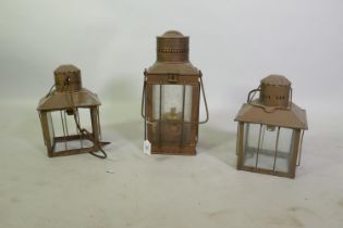 A copper lantern with paraffin burner, 37cm high, and a pair of brass hanging lanterns