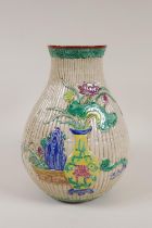 A Chinese bamboo style moulded vase with raised famille rose decoration of peaches and vases of
